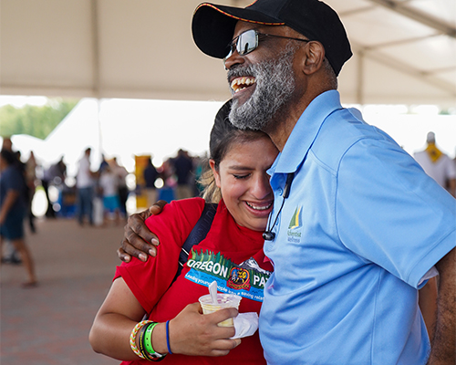 Byron Dulan, vice president for regional affairs of the North Pacific Union Conference, embraces Ashley Castro, a Pathfinder from the Oregon Conference,  after she shares her desire to become pastor. 