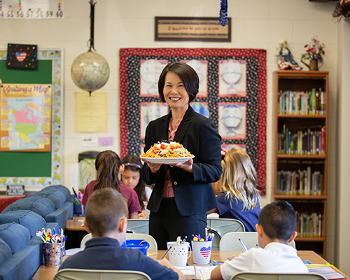 La Sierra University professor Aimee Leukert with a haystack