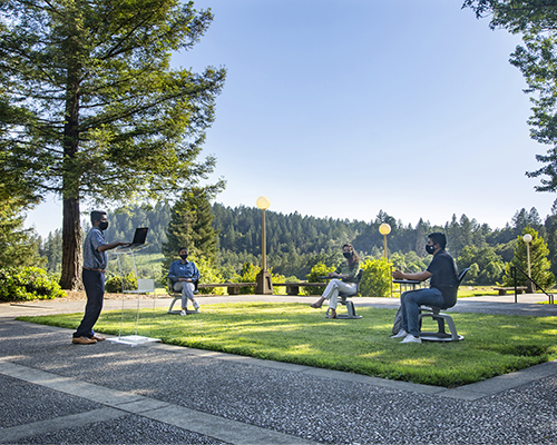 Rajeev Sigamoney, professor of film for Pacific Union College, leads a class outdoors on the school’s campus while exercising social distancing protocols. 