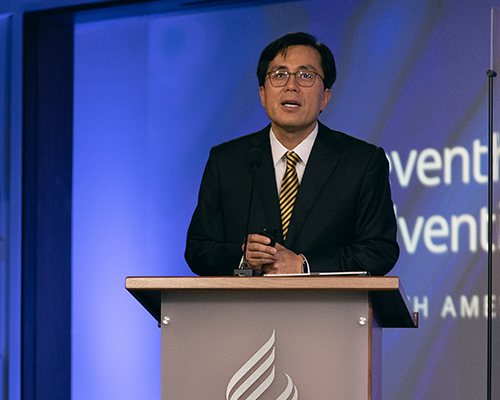 Kyoshin Ahn delivers secretary's report.