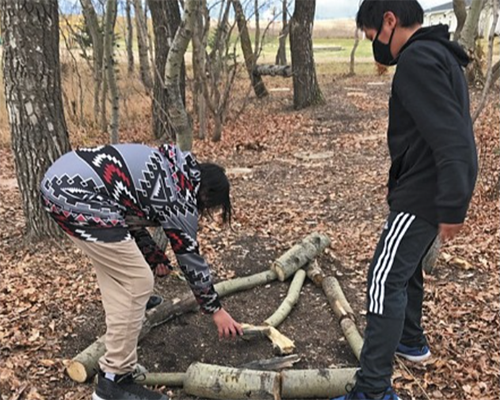 MANS students outside with tree limbs