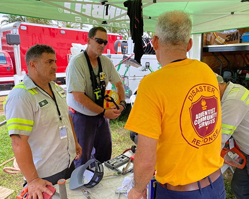 ACS emotional/spiritual care worker walks to rescue worker in Miami