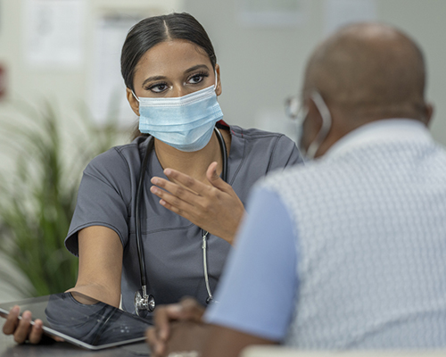 email nurse talking to elderly patient