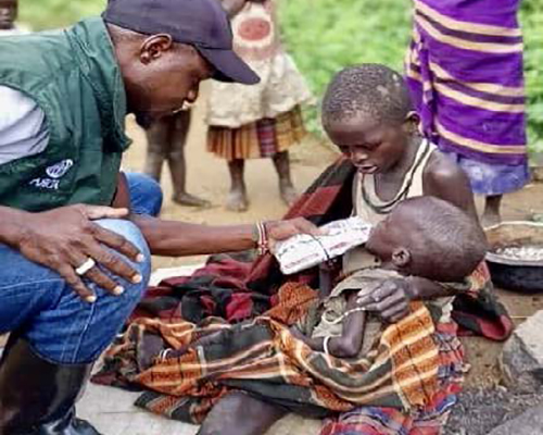 ADRA worker helps children in Uganda