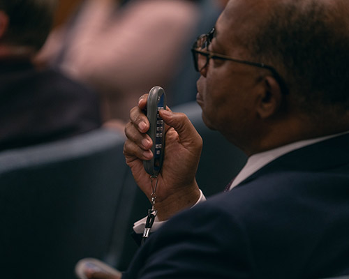 2022 NAD YEM day four photo of delegate about to vote with device