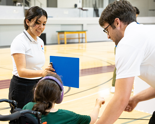 SWAU kinesiology students with community member