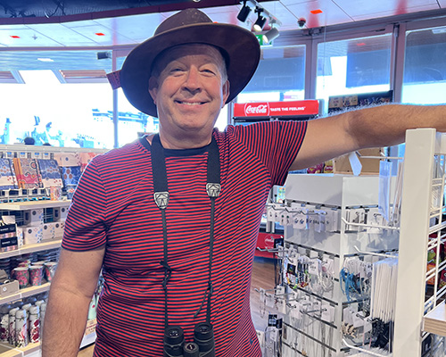 Arne Nielsen (caucasian middle aged man with bird watching binoculars and hat)