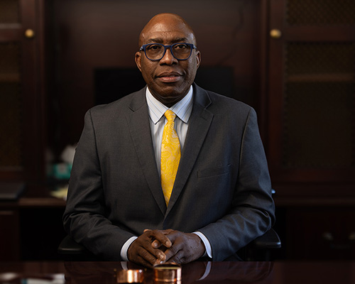 Dr. Christon Arthur (middle age Black man with glasses)