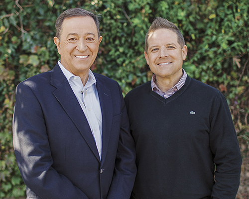 two men smiling at the camera