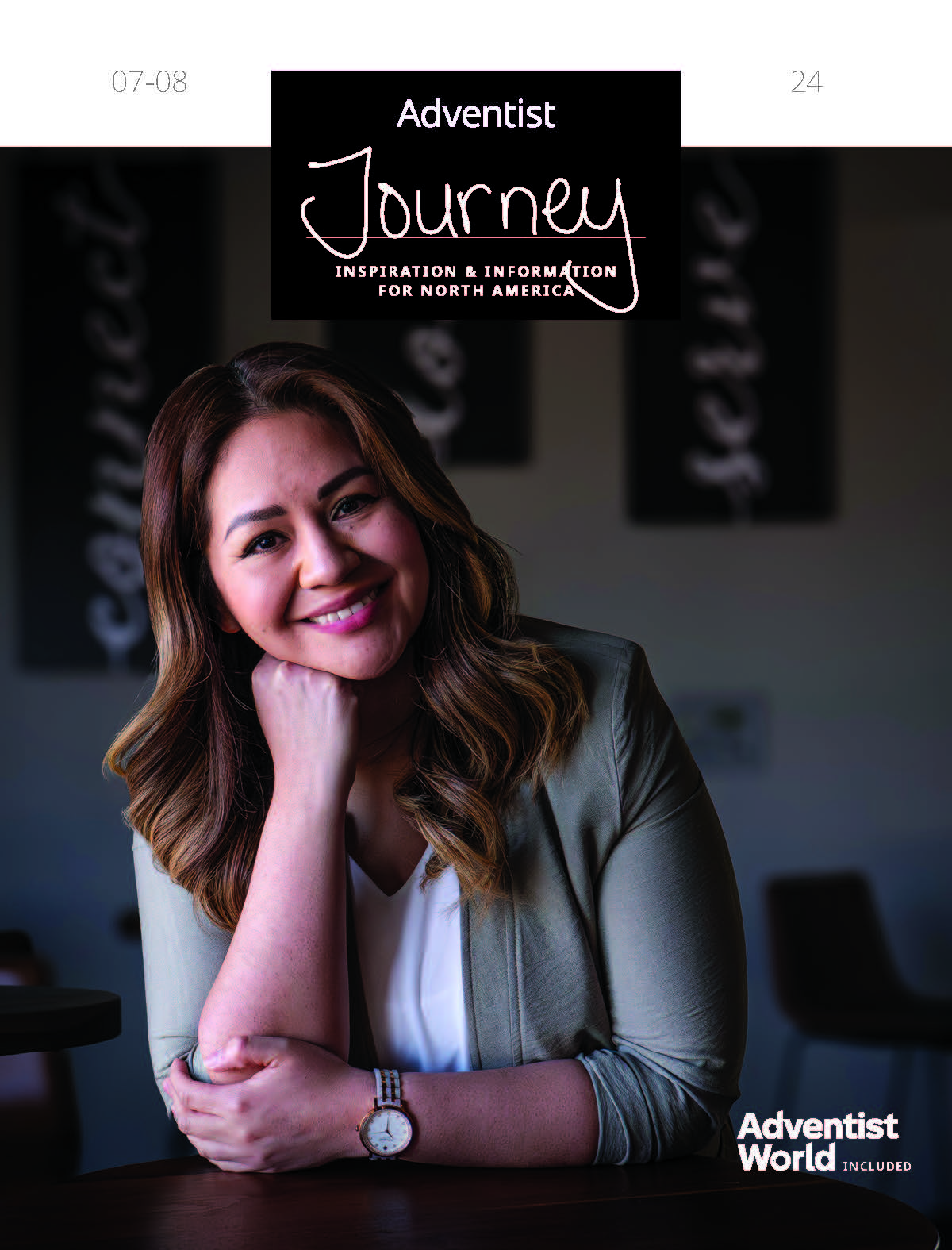 Woman smiling and looking towards the camera in business attire.