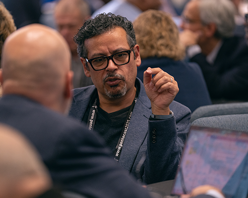 Two men in an intense discussion at a conference