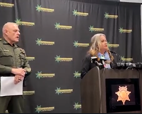 Woman speaks into microphone at press conference