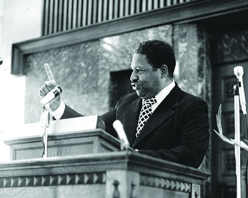 Charles E. Bradford, African American man, preaching at pulpit