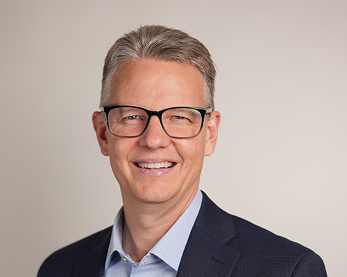 Headshot of a man in a suit