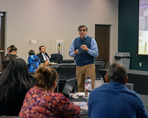 Hispanic man speaks to a small group
