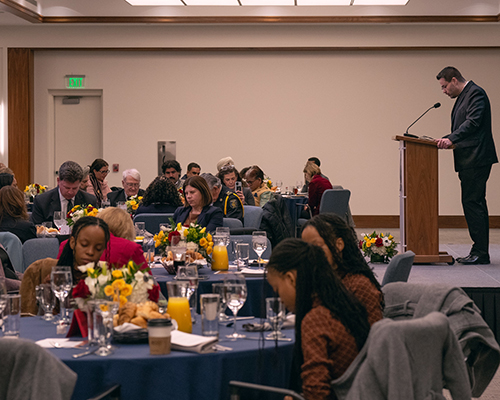 Tables of people enjoy meals, conversation and prayer at the prayer breakfast