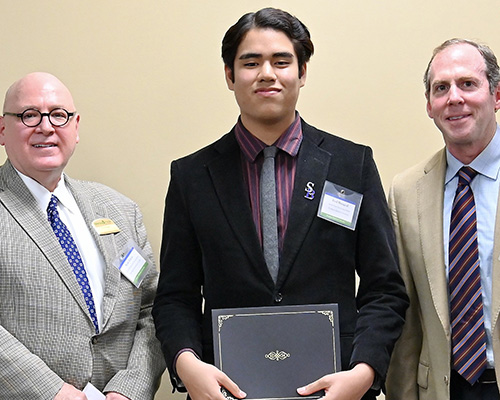 Southern Adventist University student Fred Hutagaol (center) is presented with the scholarship by Morning Point administrators Franklin Farrow (right), co-founder and chief executive officer, and Scott Edens (left), vice president for professional development. Photo provided by Southern Adventist University