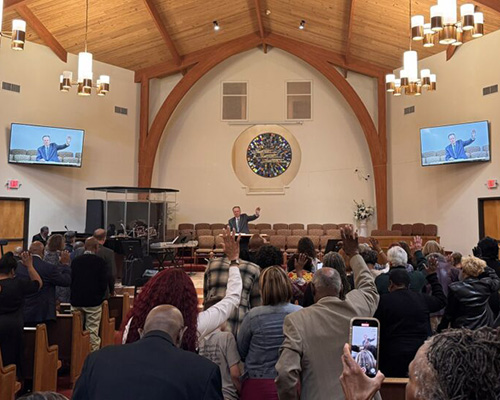 Older caucasian man preaching at an Adventist church in St. Louis, Missouri