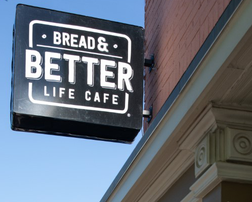 Sign of Bread and Better Life Cafe displayed outside of the ministry on the streets of Fort Worth, Texas.