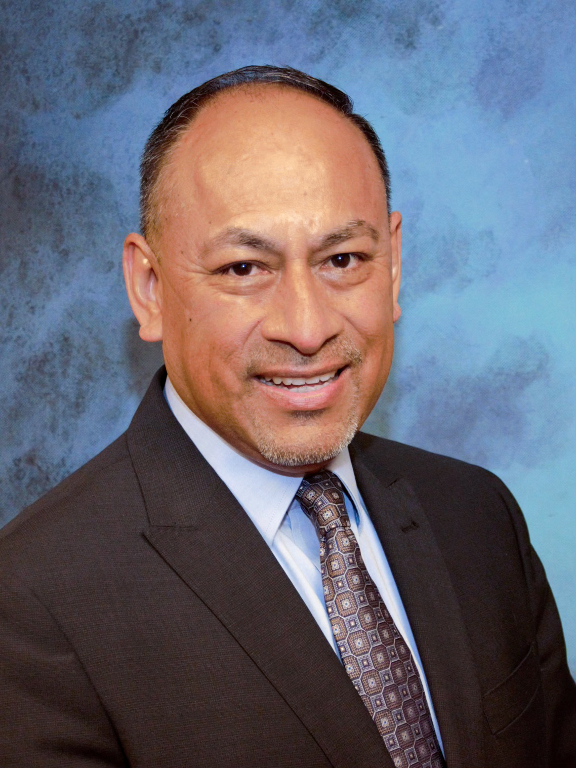 Man smiling into camera.