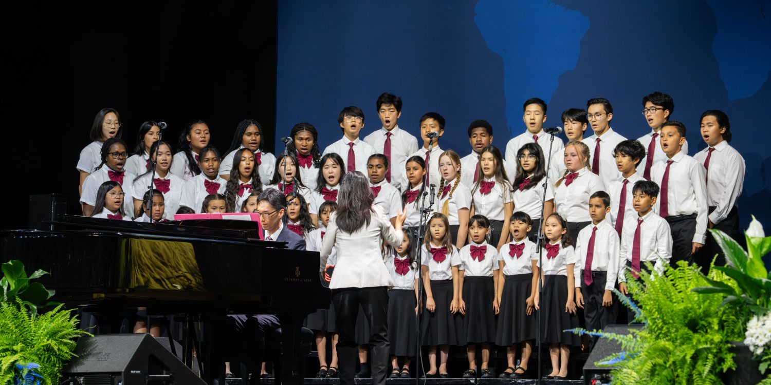 Children sing on the stage at the GC session. 