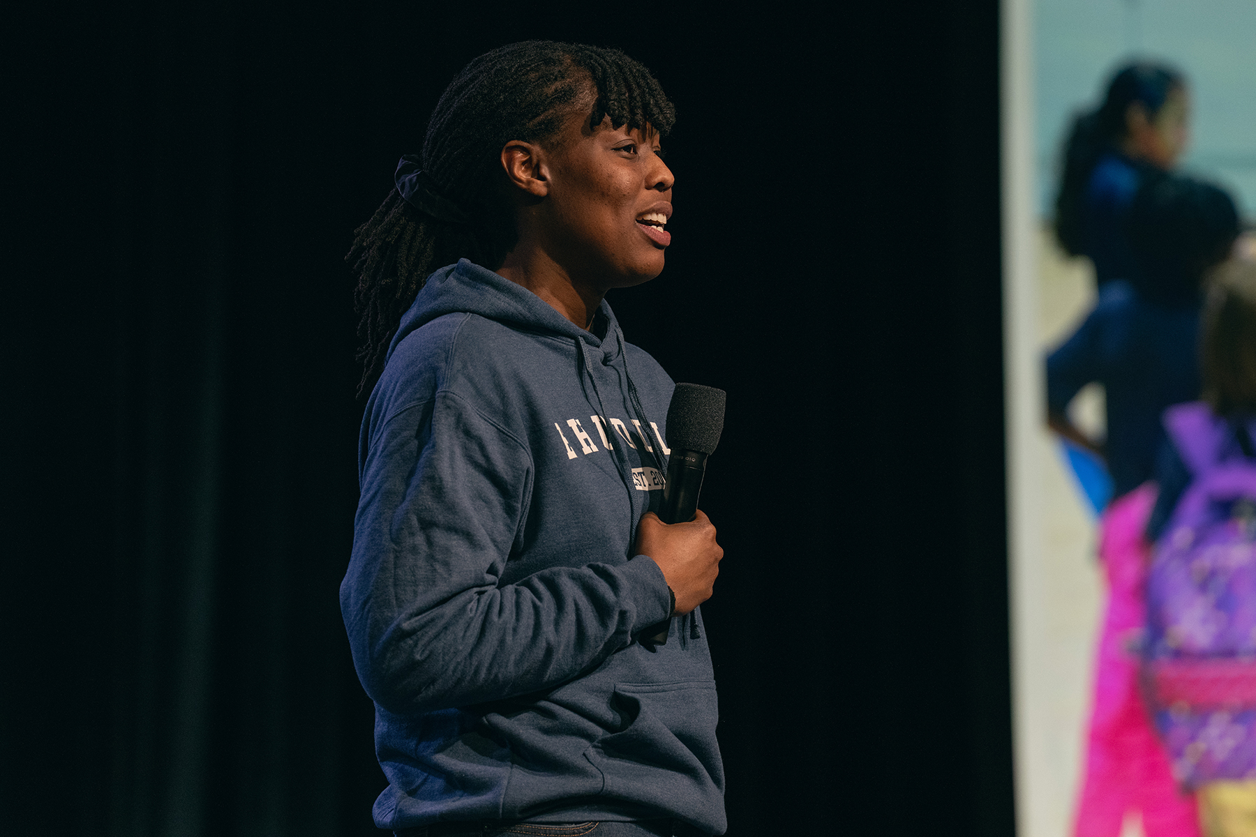 Black woman speaking on a stage