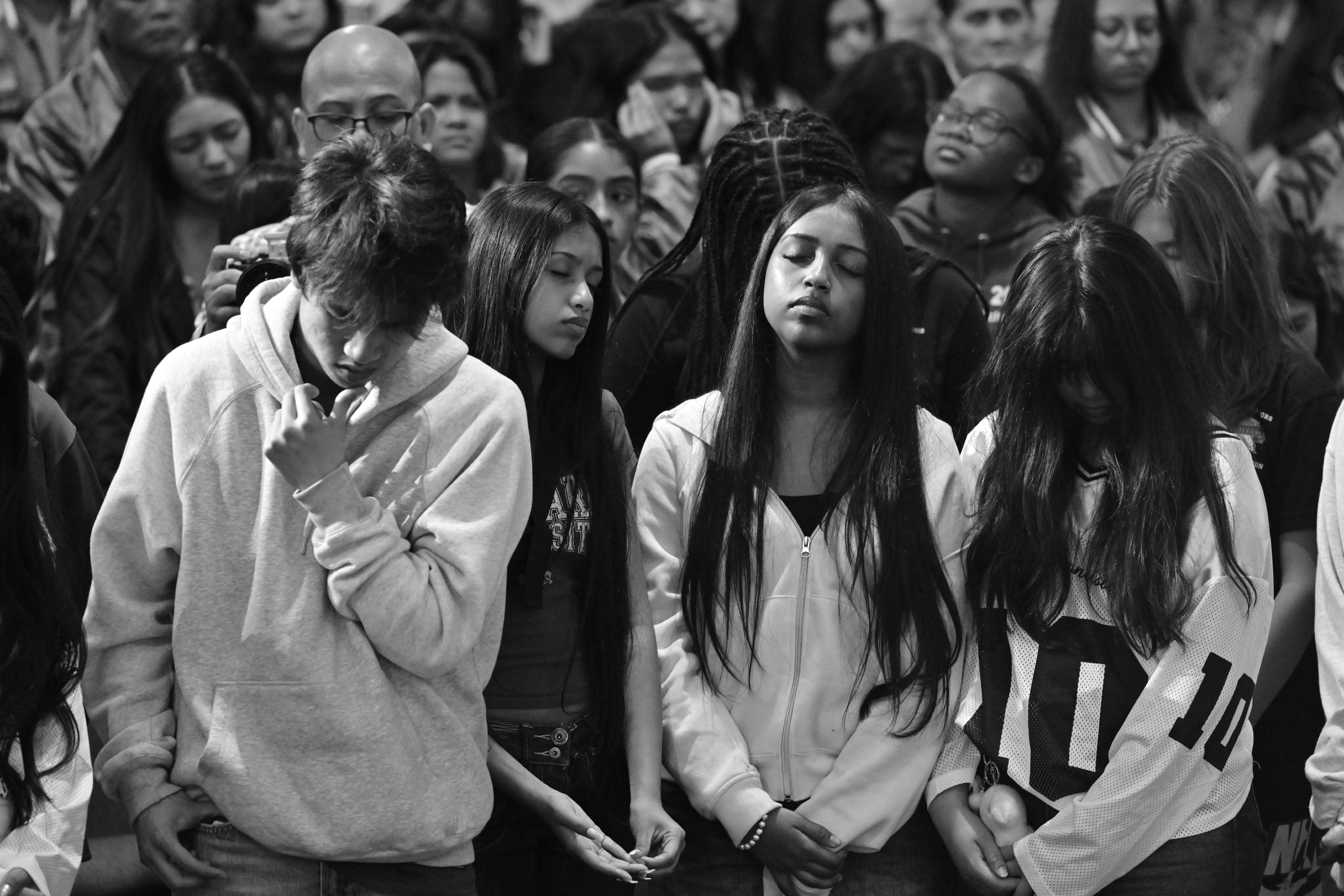 Black and white photo of young people praying