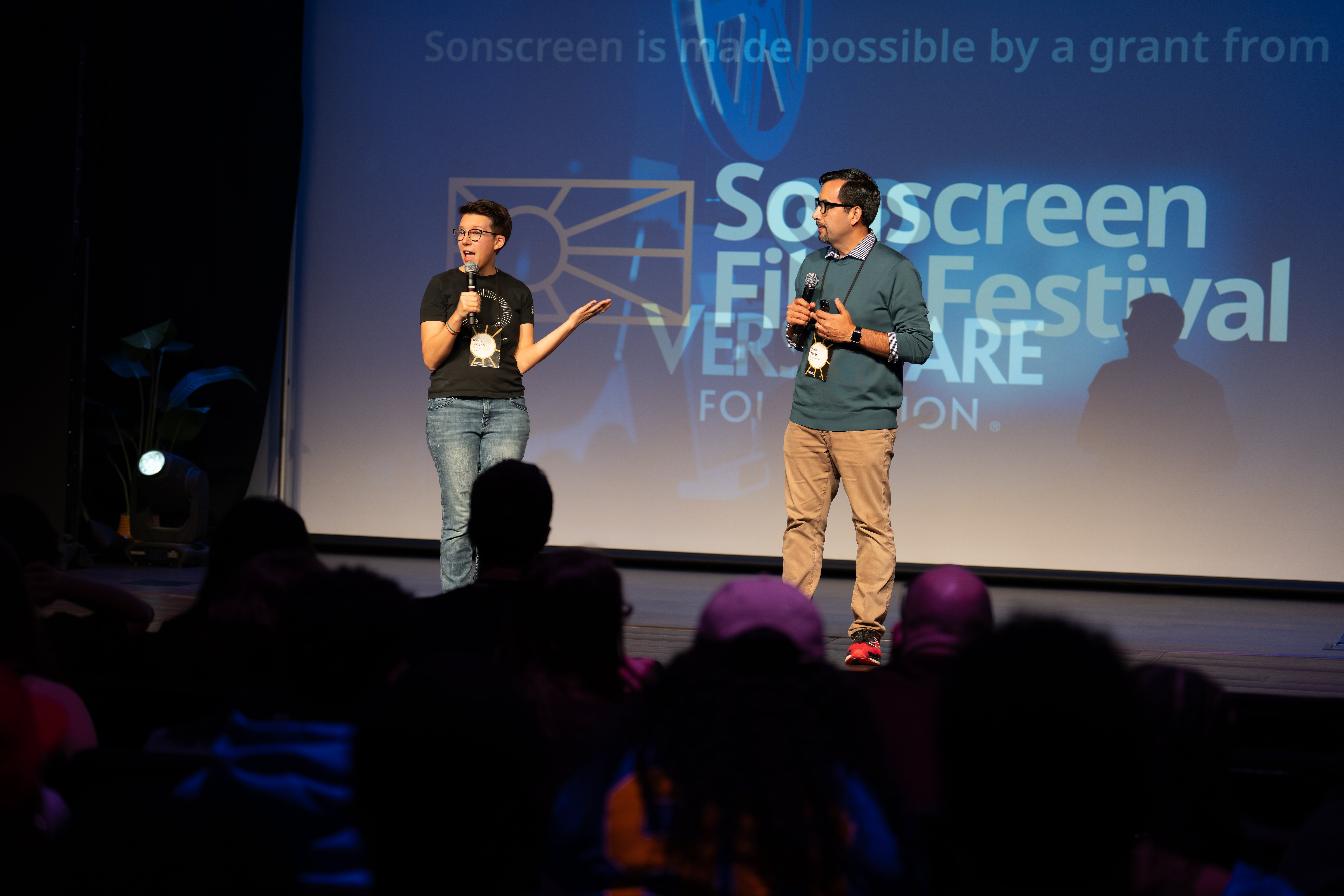 A woman and man talking on Sonscreen stage.