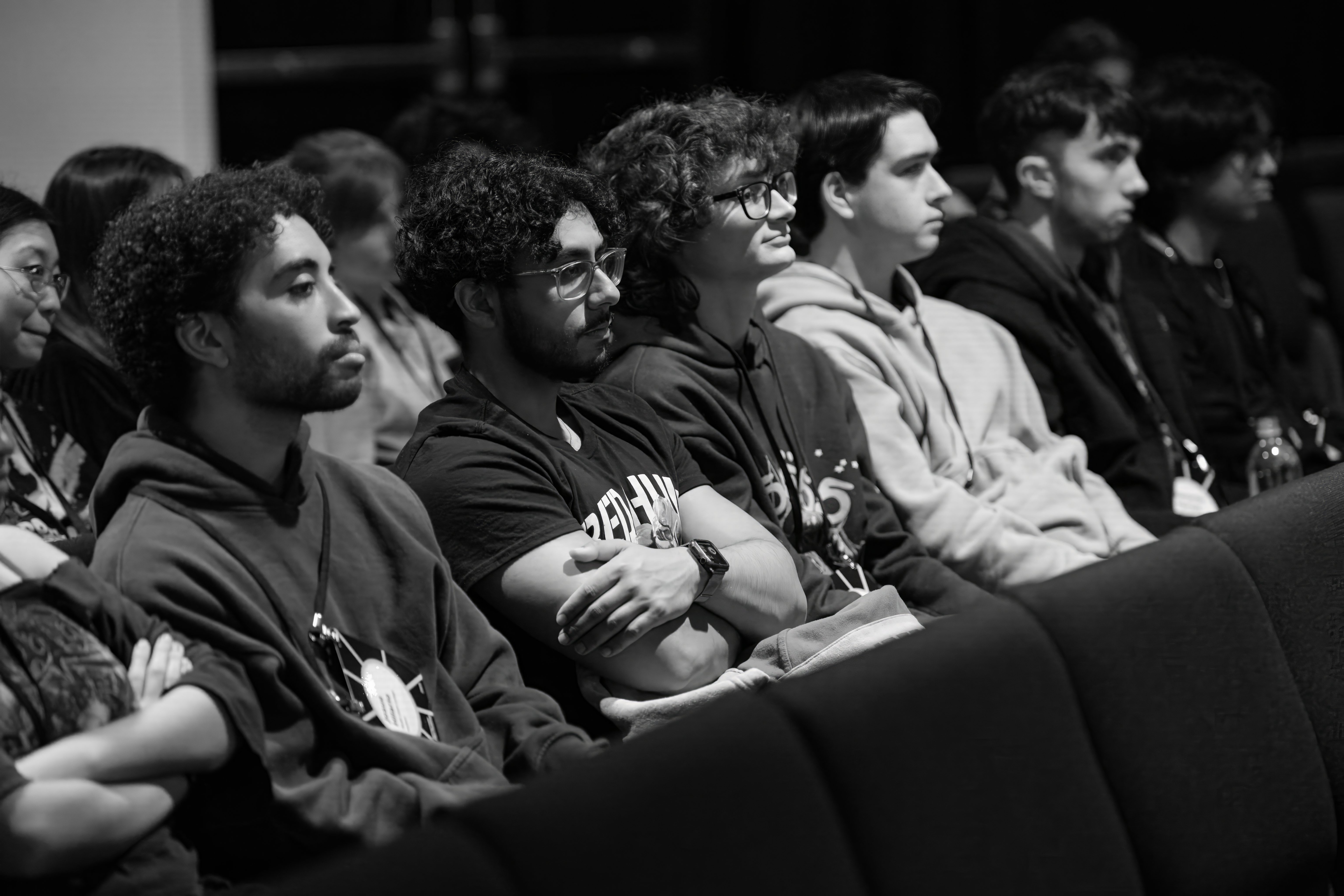 Black and white photo of young men in a row seated