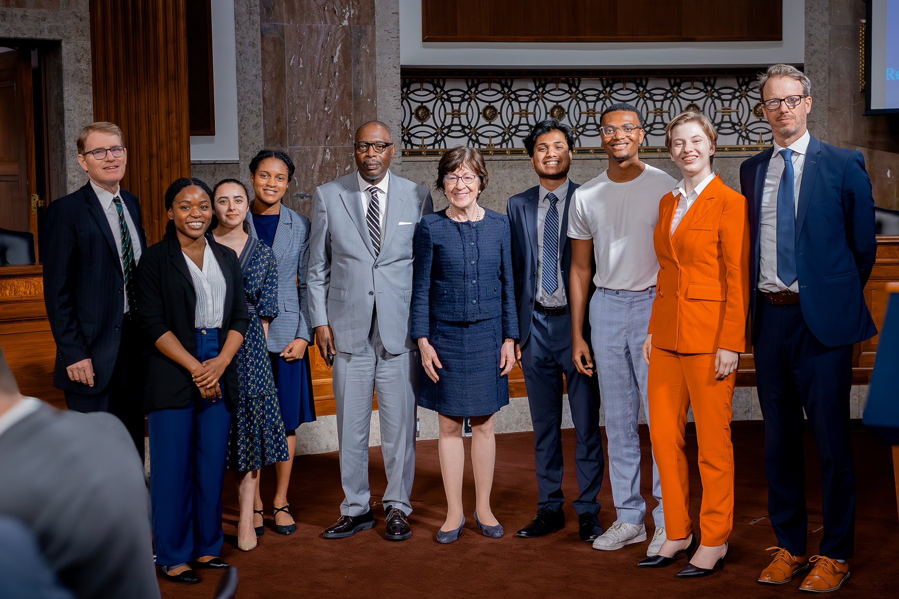 A photo of a diverse group of individuals in professional wear