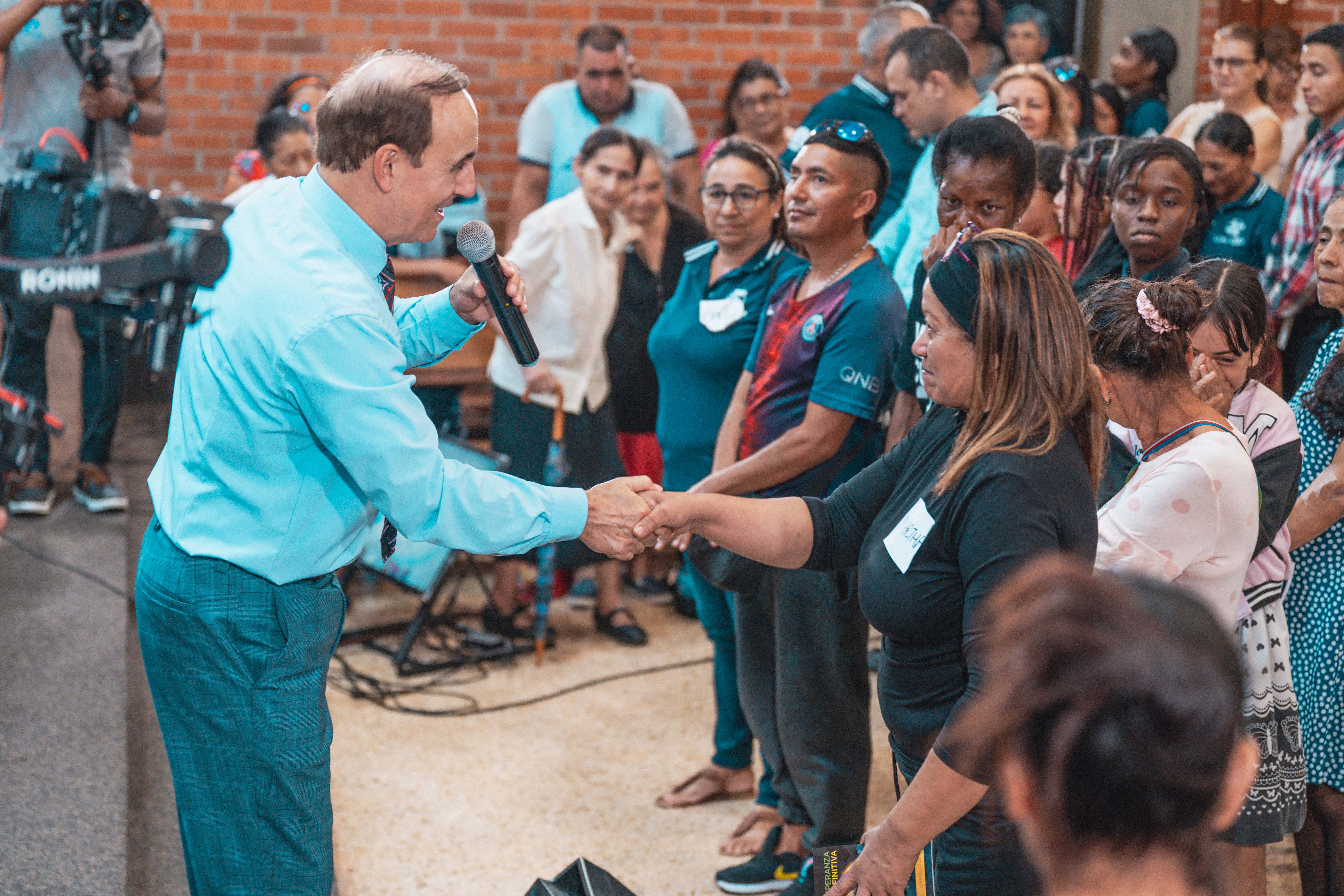 In Cali, Colombia, Pastor Robert Costa connects with a woman who came forward for the appeal.
