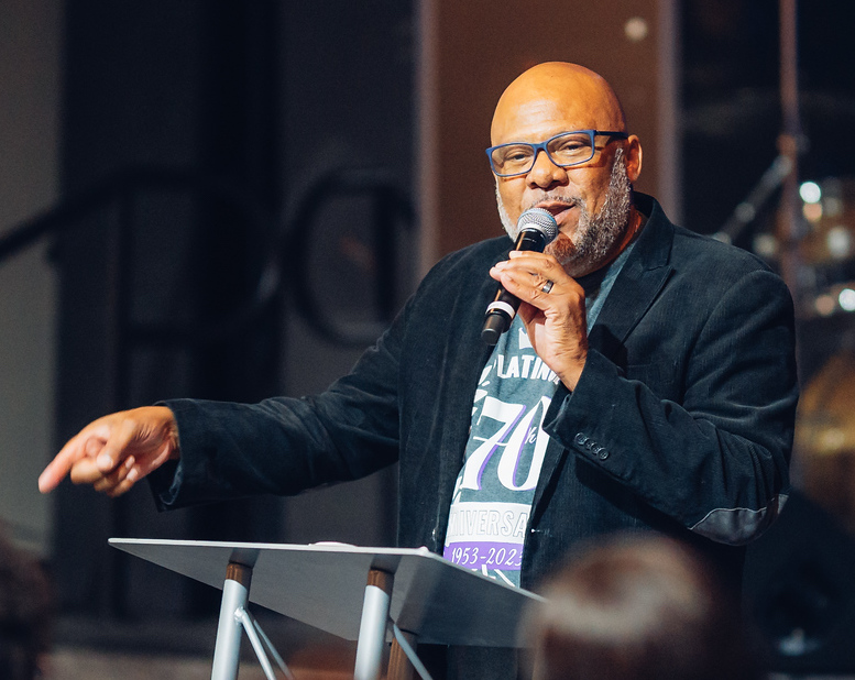 An older black man speaking at a podium