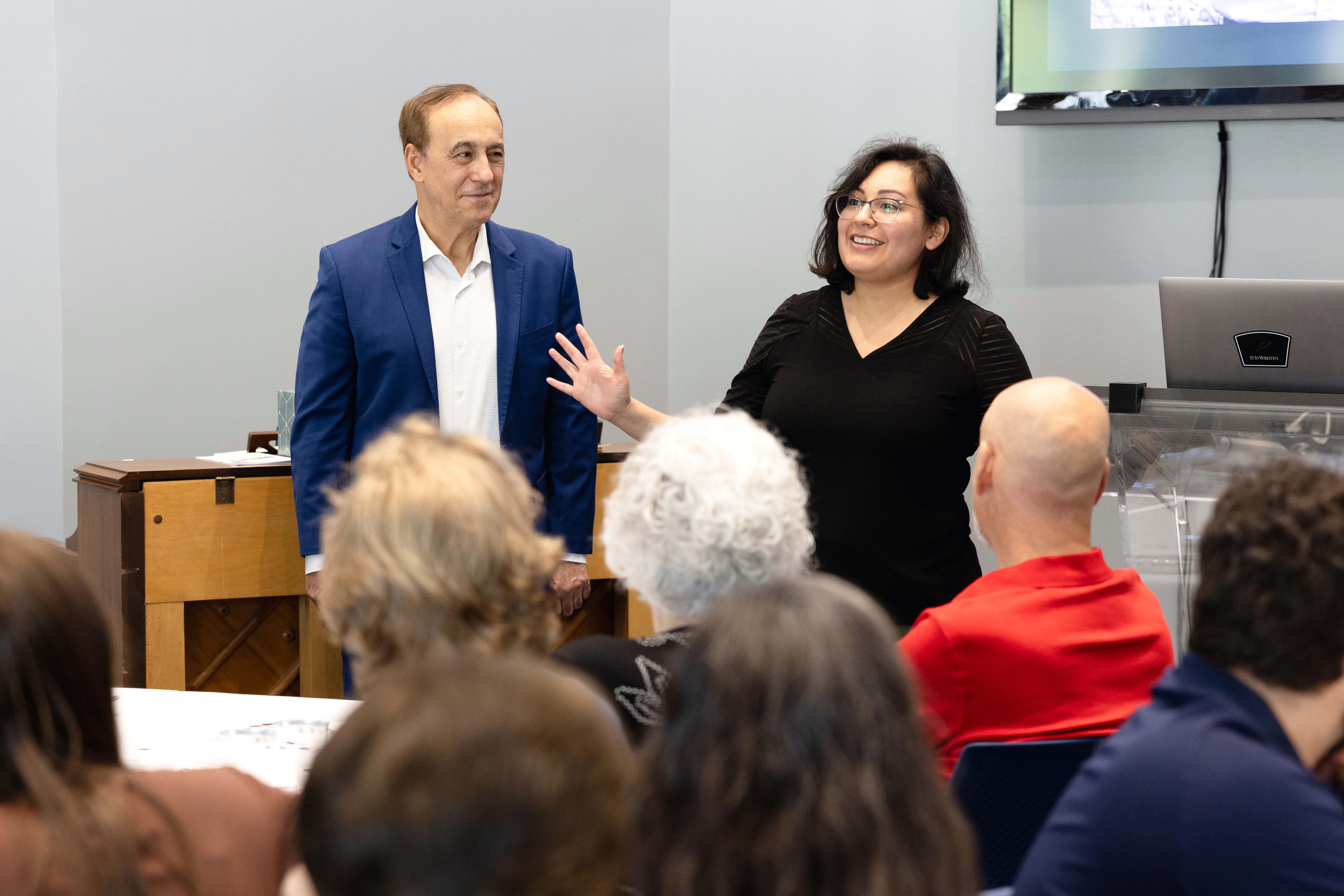 On May 1, It Is Written staff celebrated the occasion. Here, Pastor Robert Costa and Carolina Bonilla, Escrito Está coordinator, express their gratitude to God and the staff for their support.