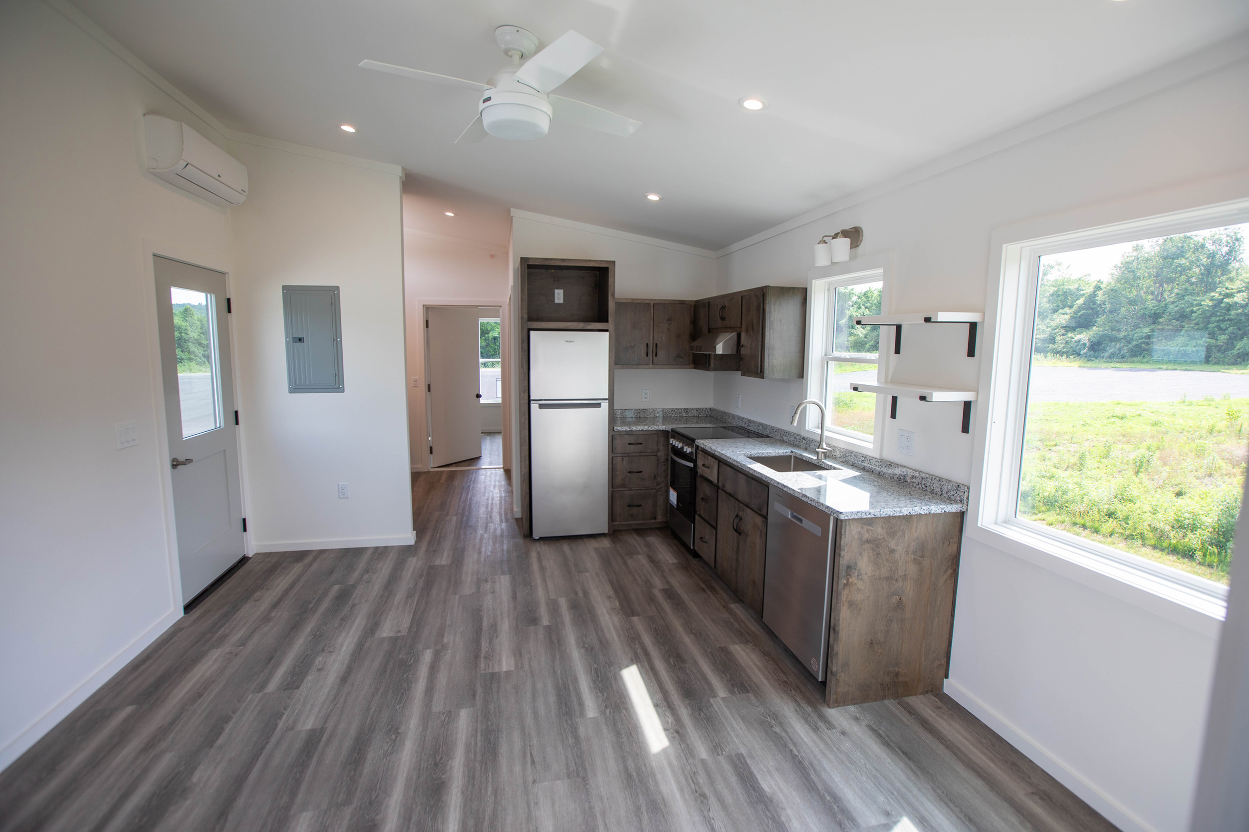 An empty home interior featuring a kitchen and living room area.