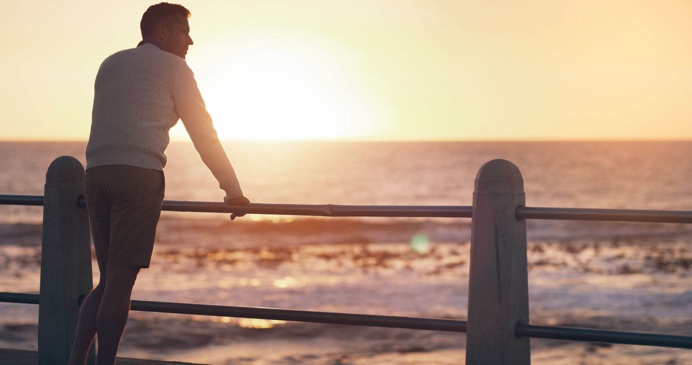 stock photo of man looking out at water