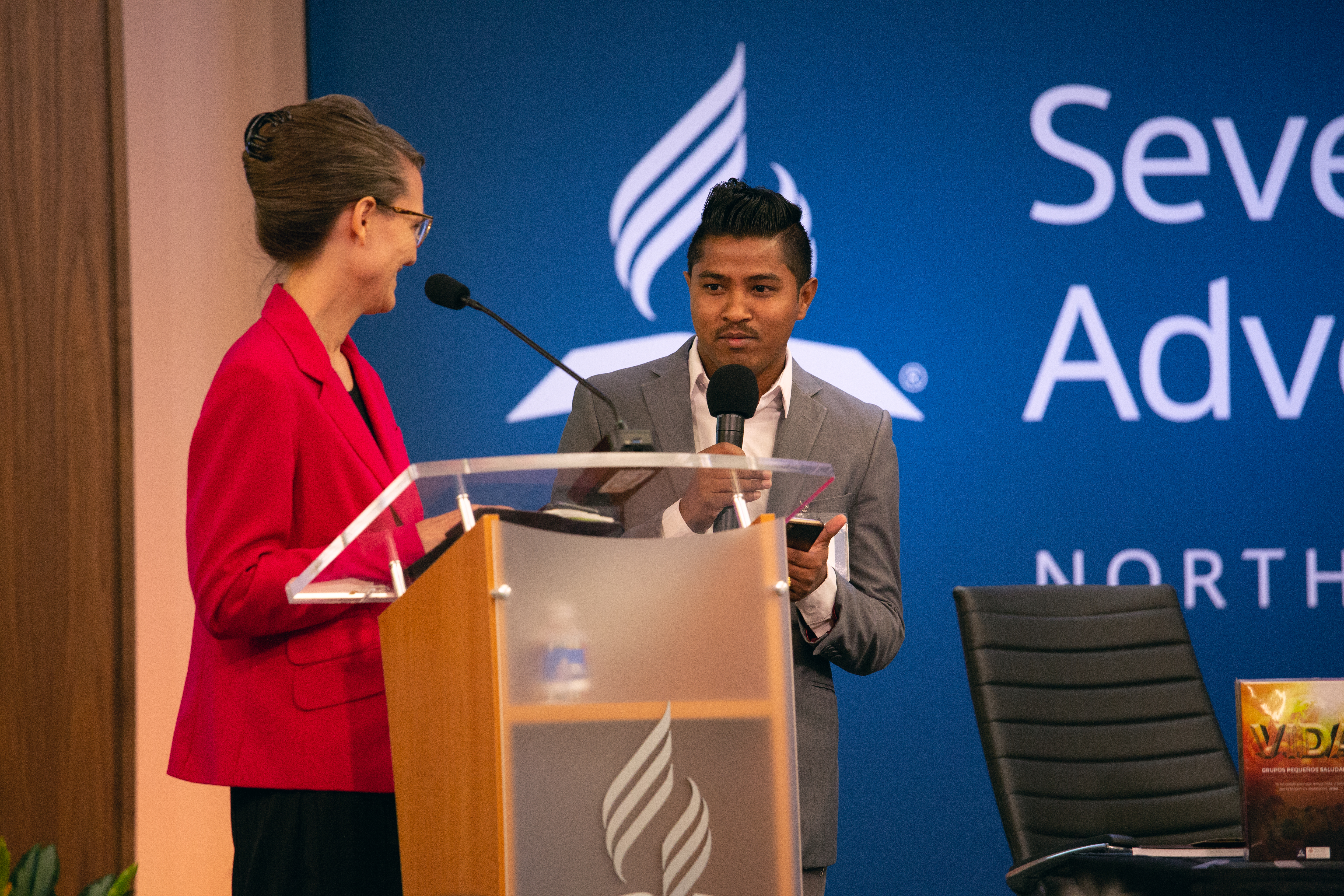 Terri Saelee, NAD coordinator for Refugee and Immigrant Ministries, gives her YEM report with a ministry colleague. Photo by Pieter Damsteegt