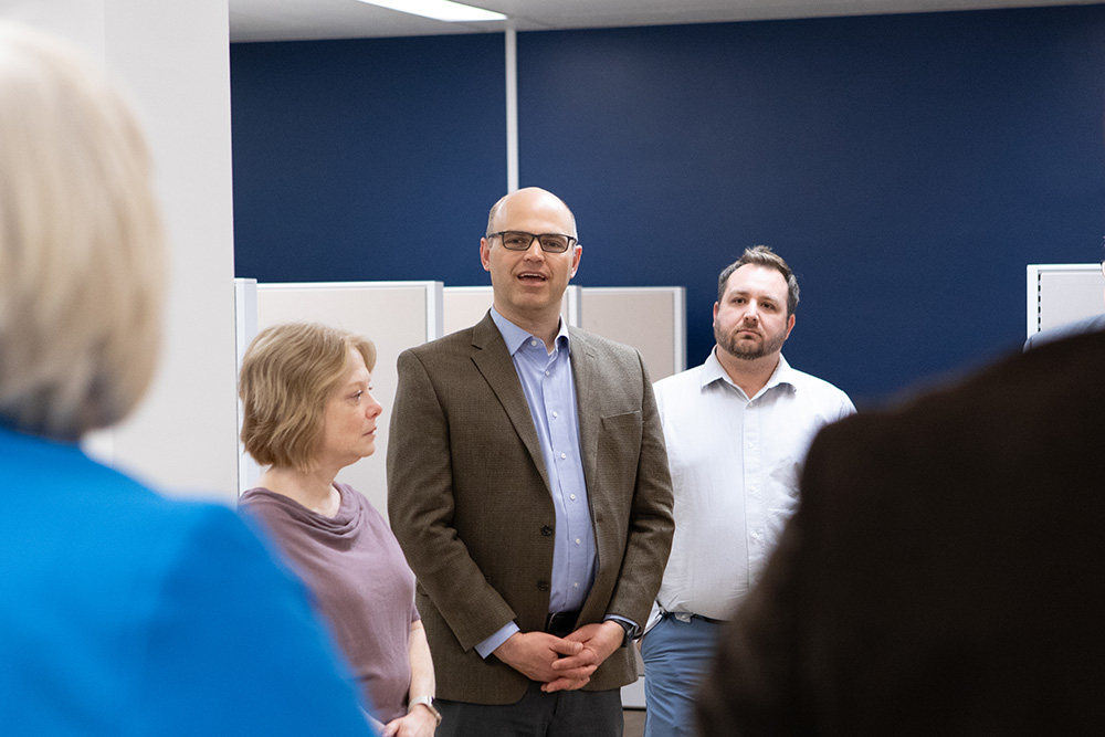 Causcasian woman and two men standing together in office setting at Adventist Connect location in College Place, Wash.