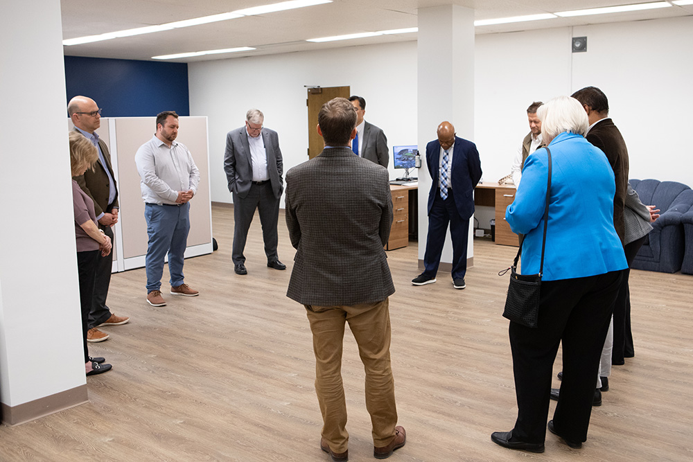 Adventist Connect group prayers at the new office on Walla Walla University campus, circle of people varying ages pray