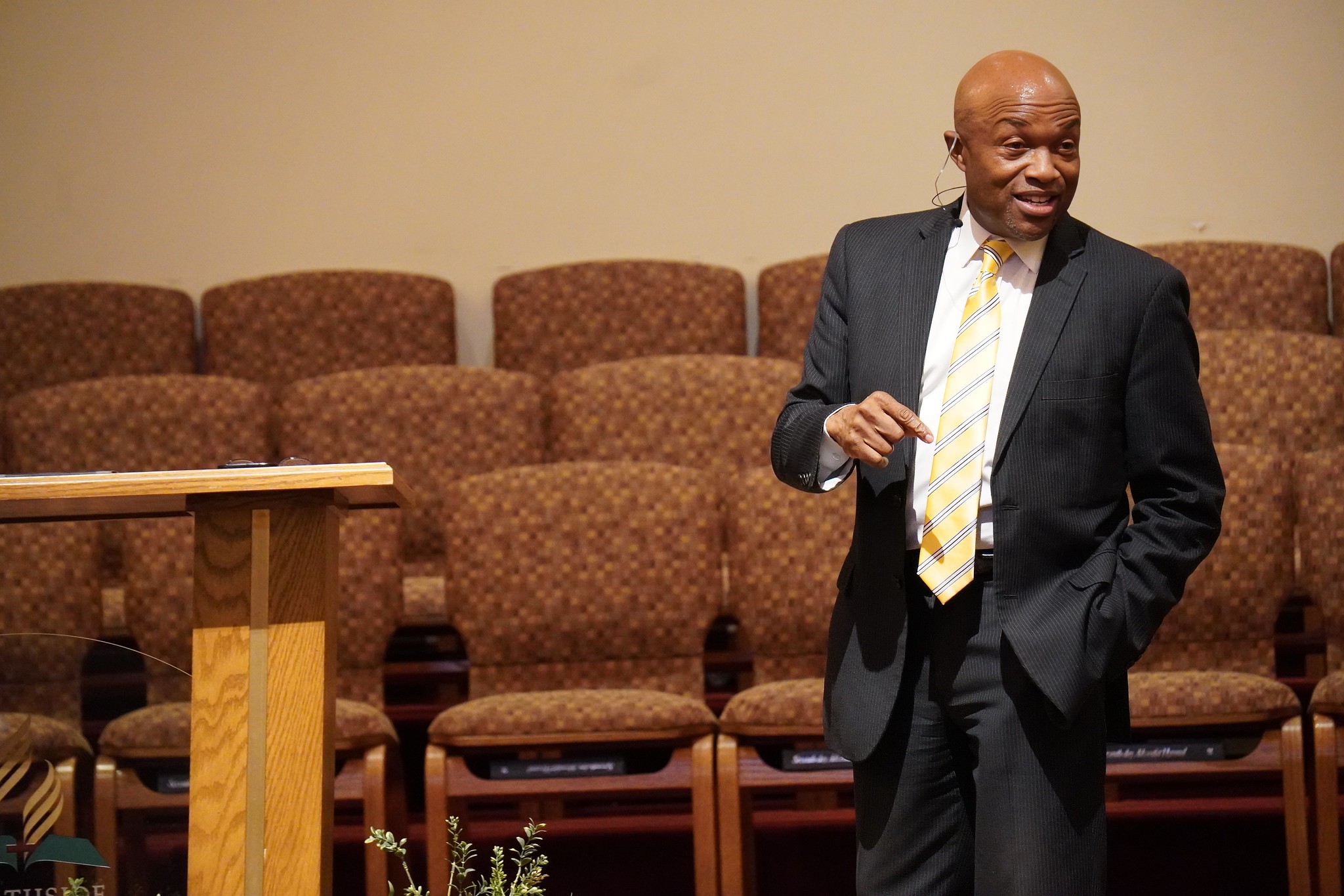 African American man in business suit speaking to a group