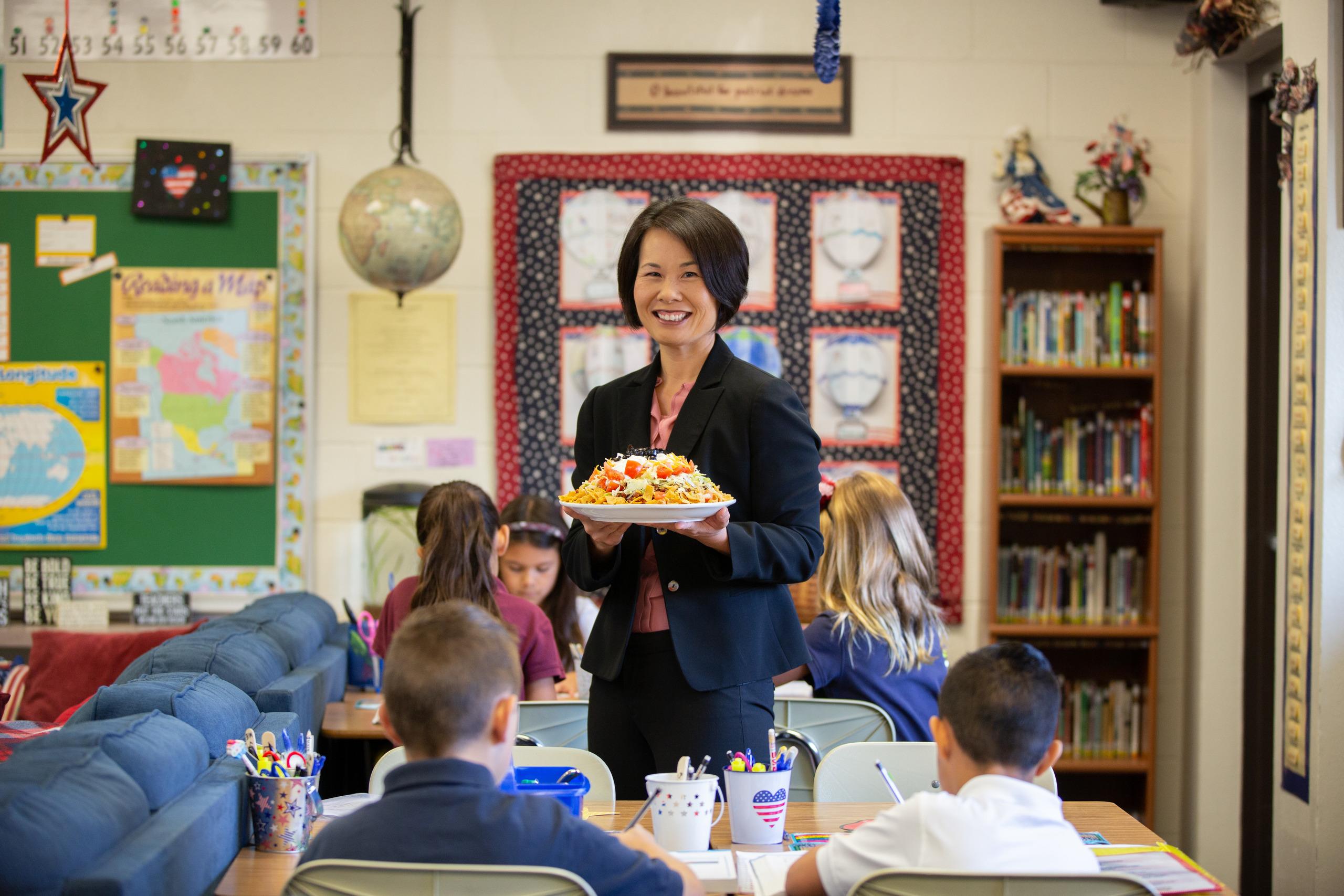 Haystack anyone? Dr. Aimee Leukert holds one of Adventism's best known iconic meals, the haystack. Around her are Loma Linda Academy students (left to right, front to back) Kolton Ice, Micah Mendez, Liana Leukert, Kayleigh Leukert, and Makena Wacker. (Photo: Natan Vigna)