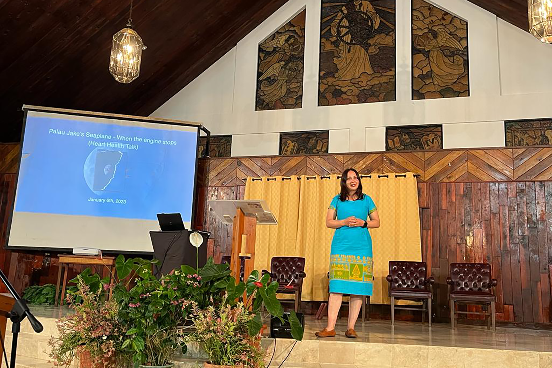 Woman standing on a platform speaking