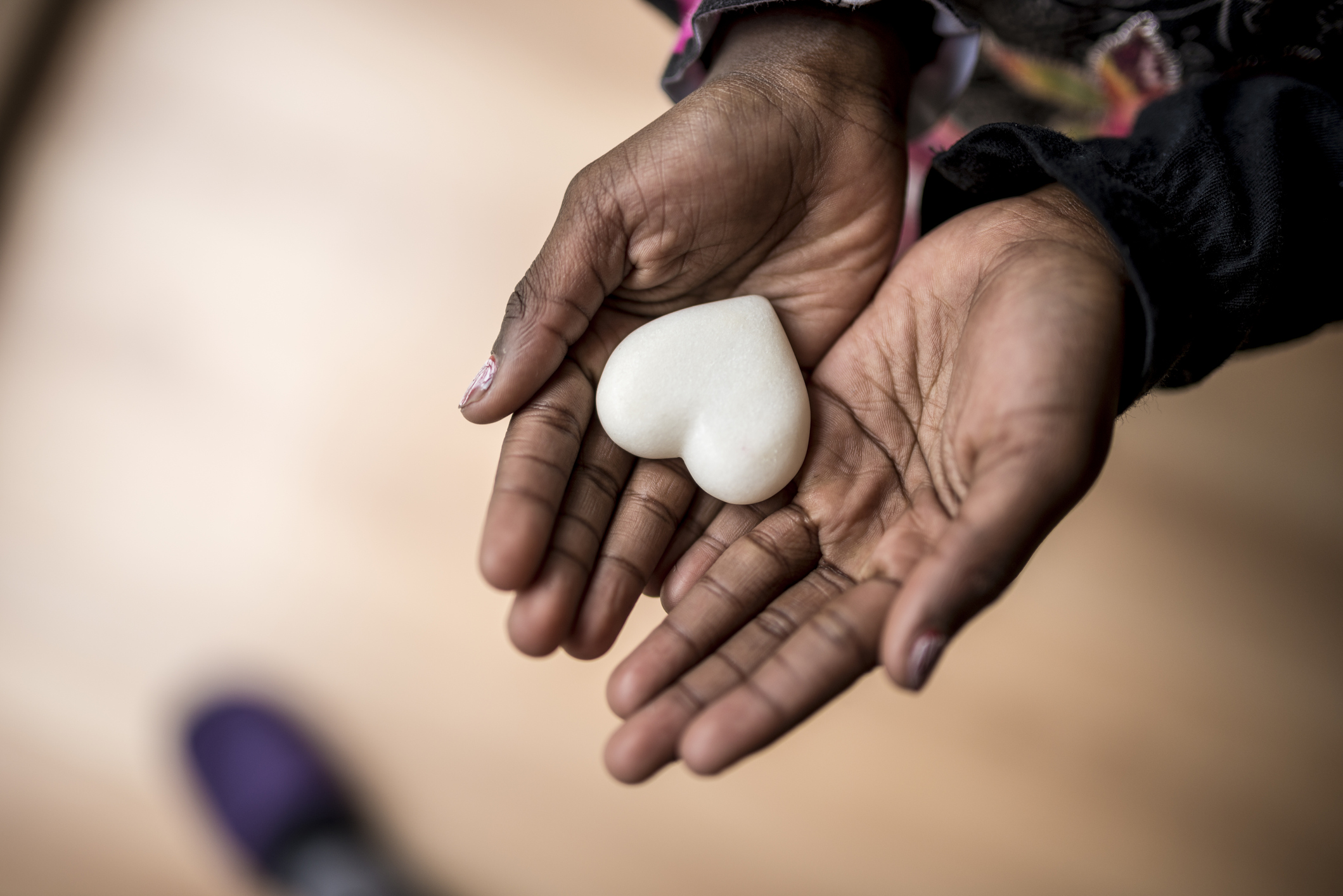 stock photo of girl holding heart shaped stone