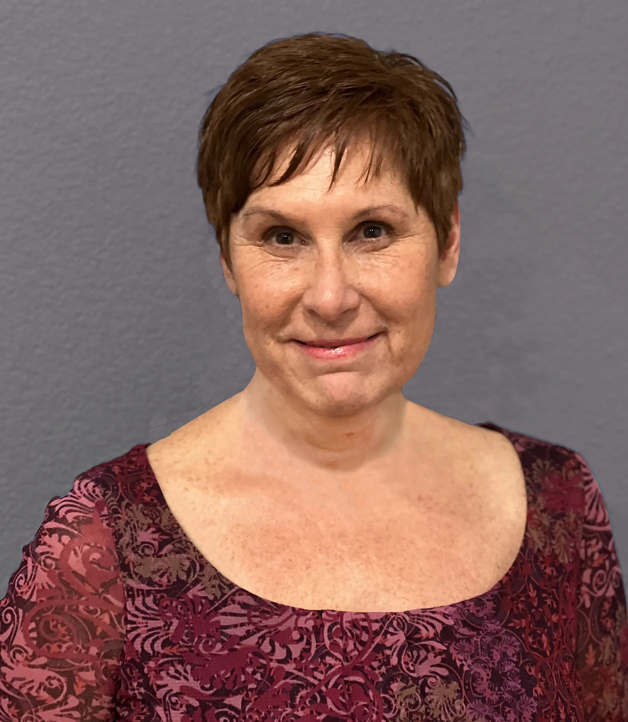 A professional headshot of a woman