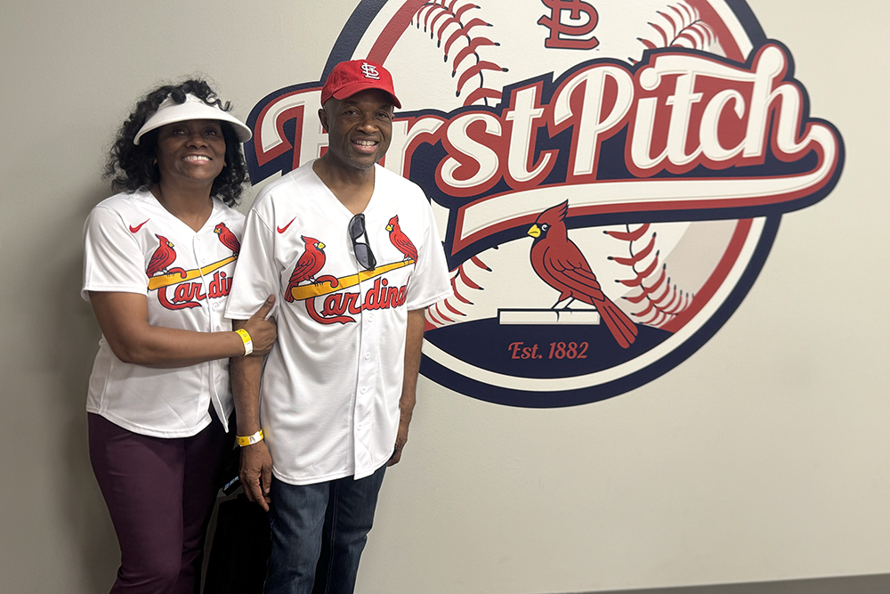 Middle aged Black married couple at St. Louis first pitch sign