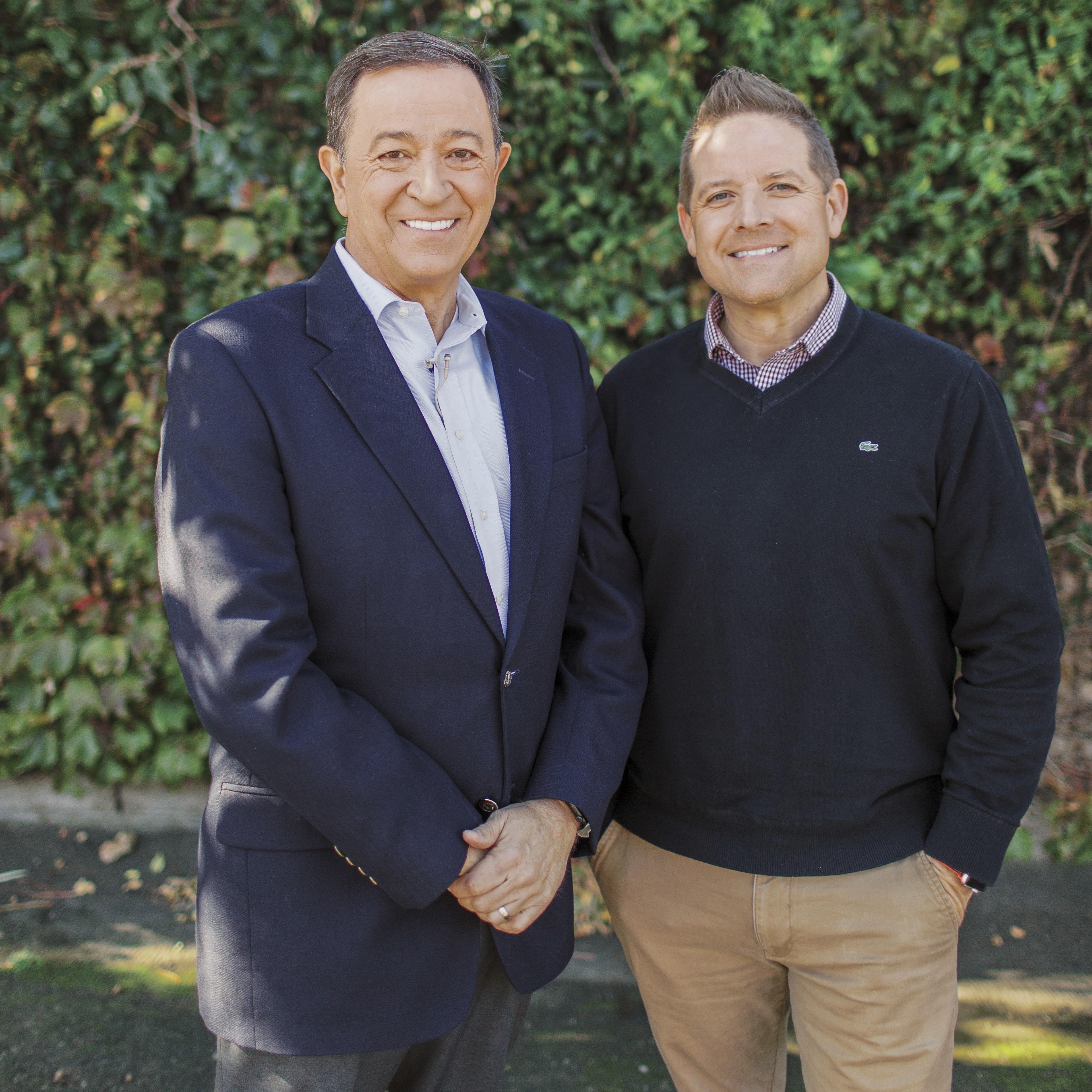Two men smiling towards the camera