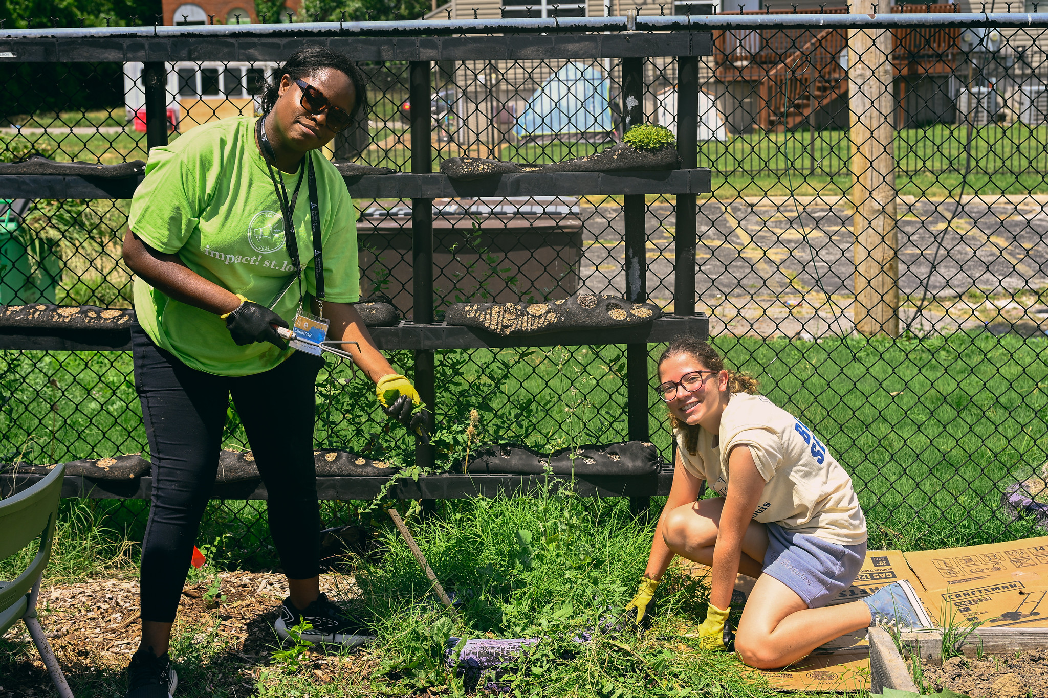 Youth volunteers with impact! st. louis assist with weed removal.