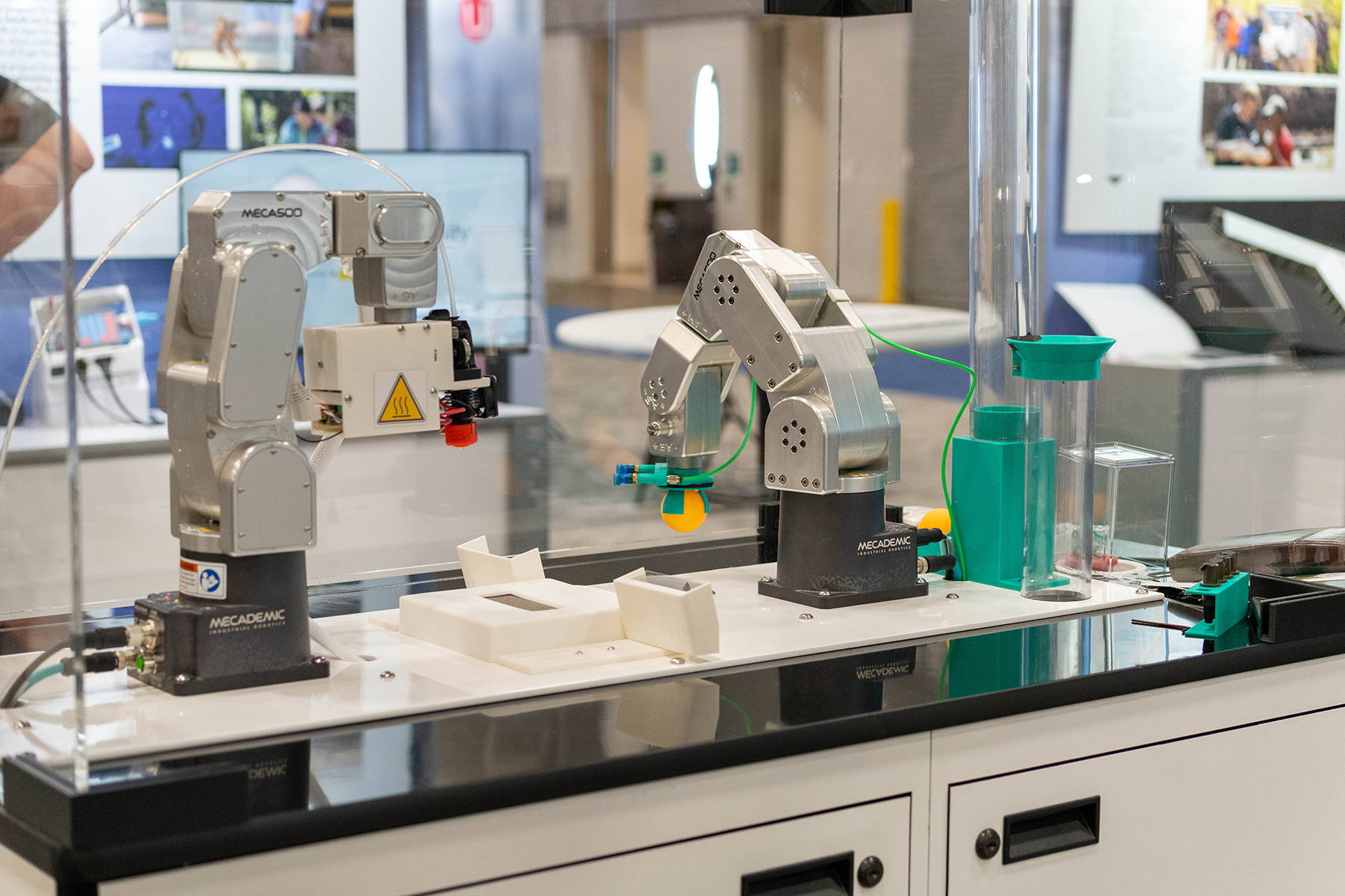 Two robots and test tubes on a white table