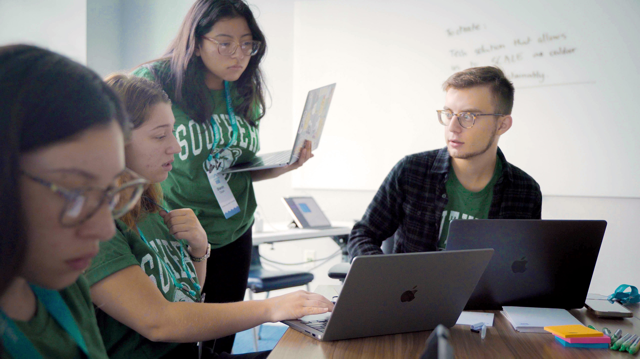 four college students in a classroom