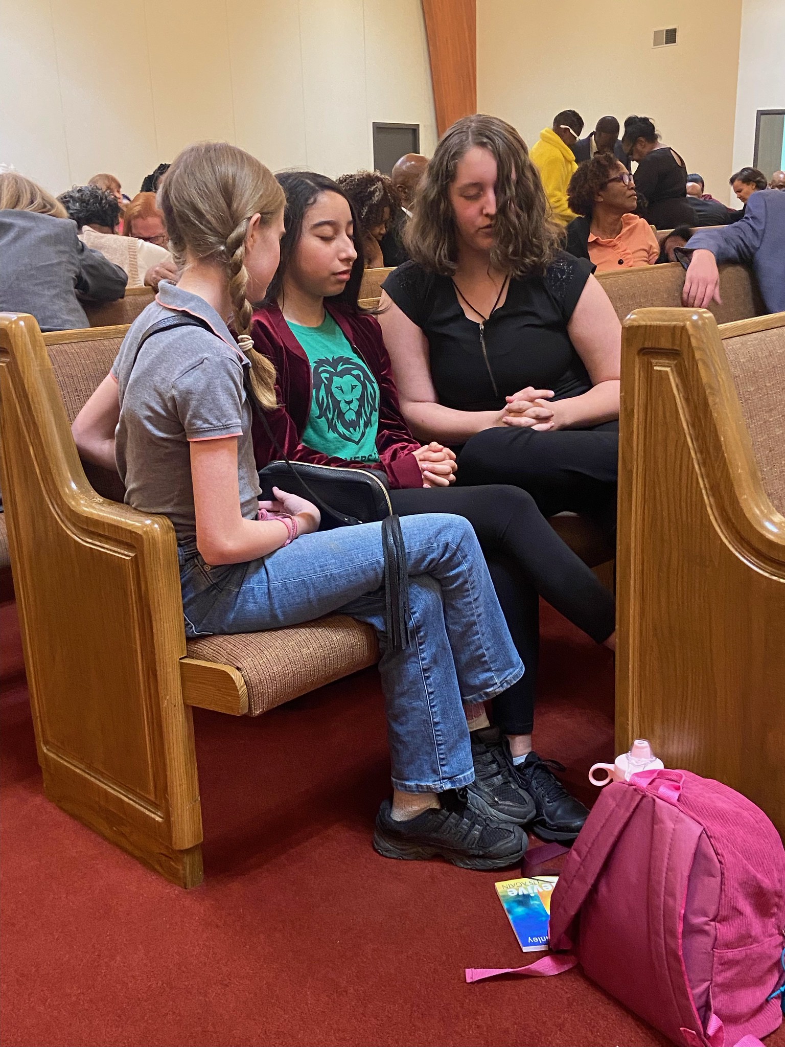 congregation praying, group of teenagers pray in a church setting 