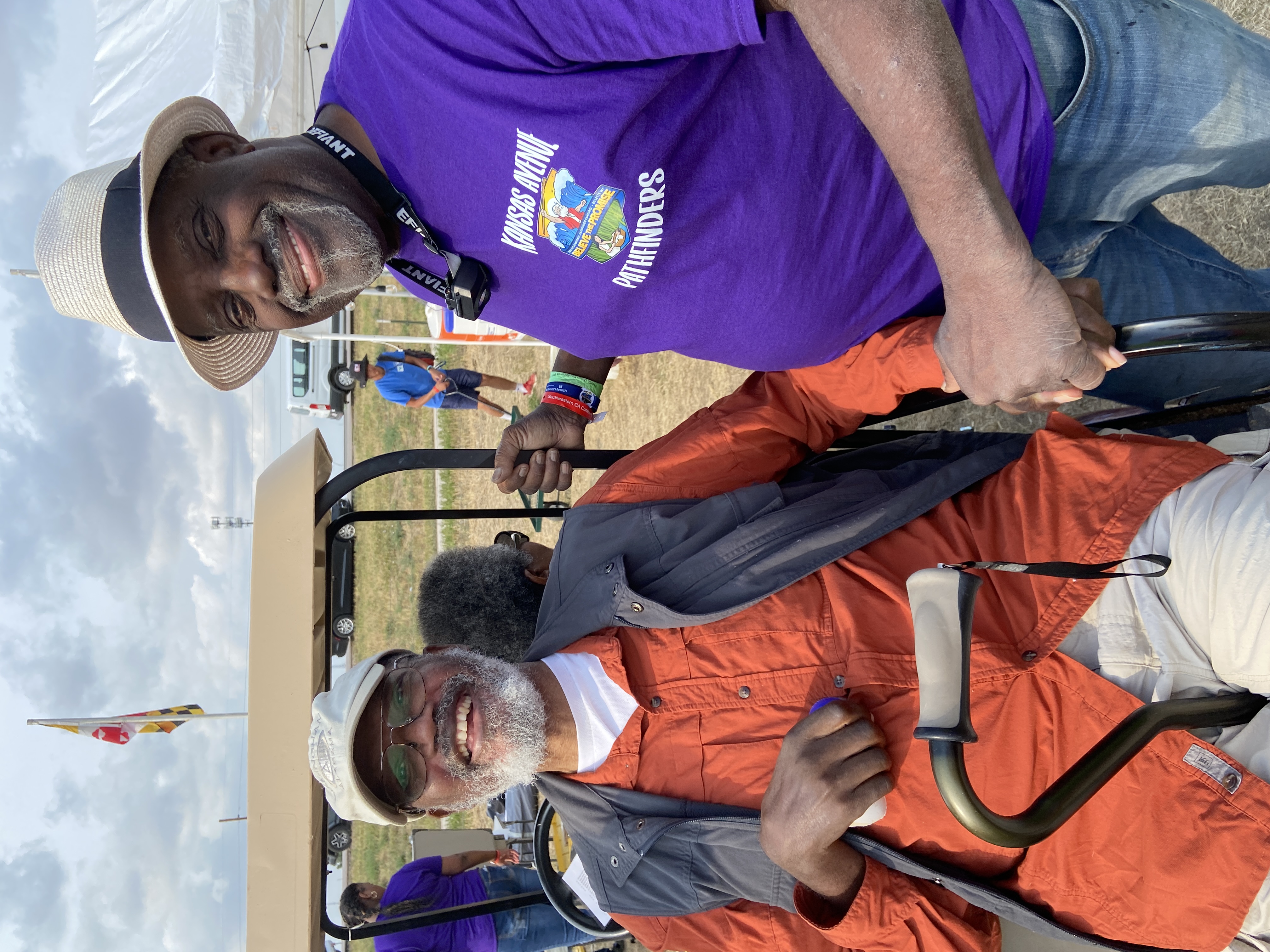 (Photo of Vernon and Robert Harris: Photo credit: Lori Peckham)  Robert Harris, director of the Kansas Ave. Pathfinder Club, gifted Vernon with a club T-shirt and a prayer of blessing.